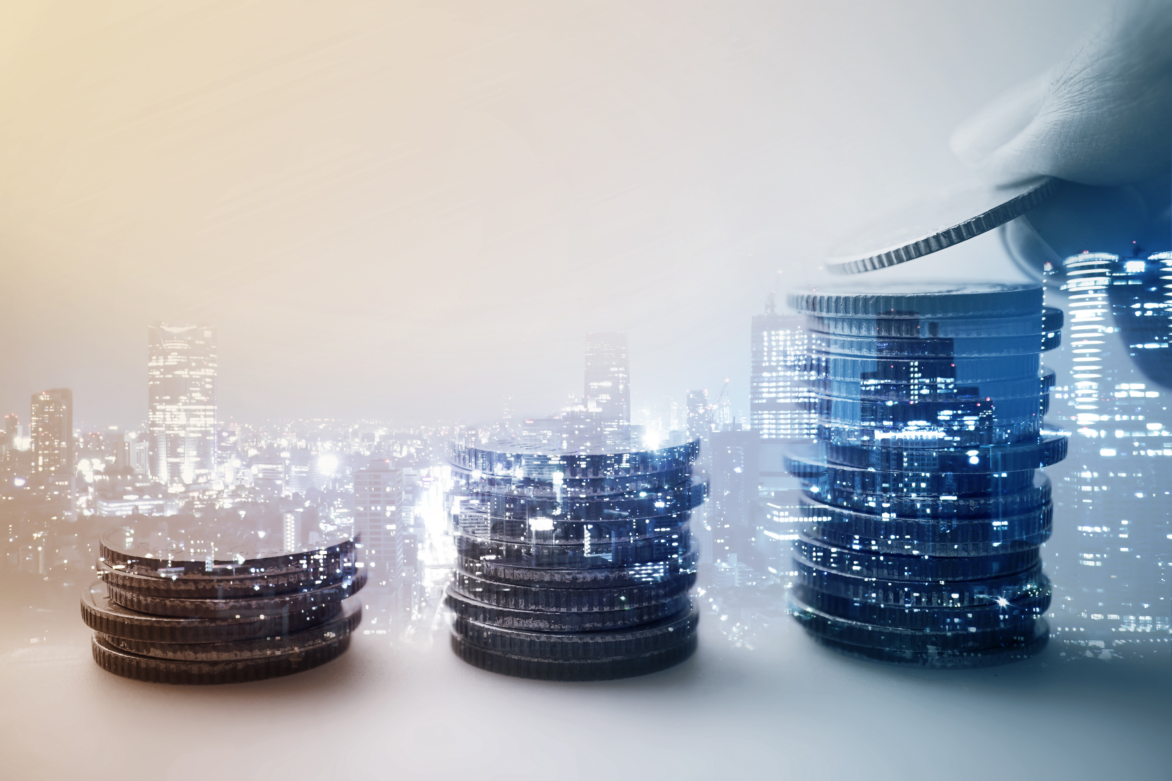 Stacked coins with the city view in the background