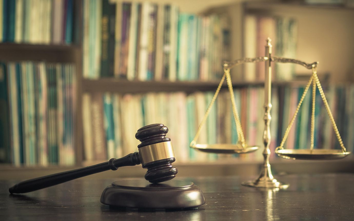 Wooden judge gavel with scales on library