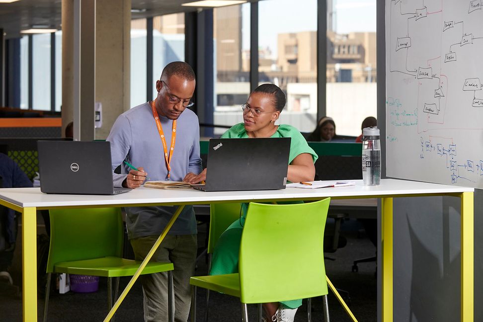 Ngulube and Mbonambi in their office working