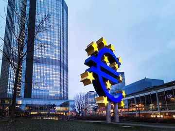 euro sign logo and buildings