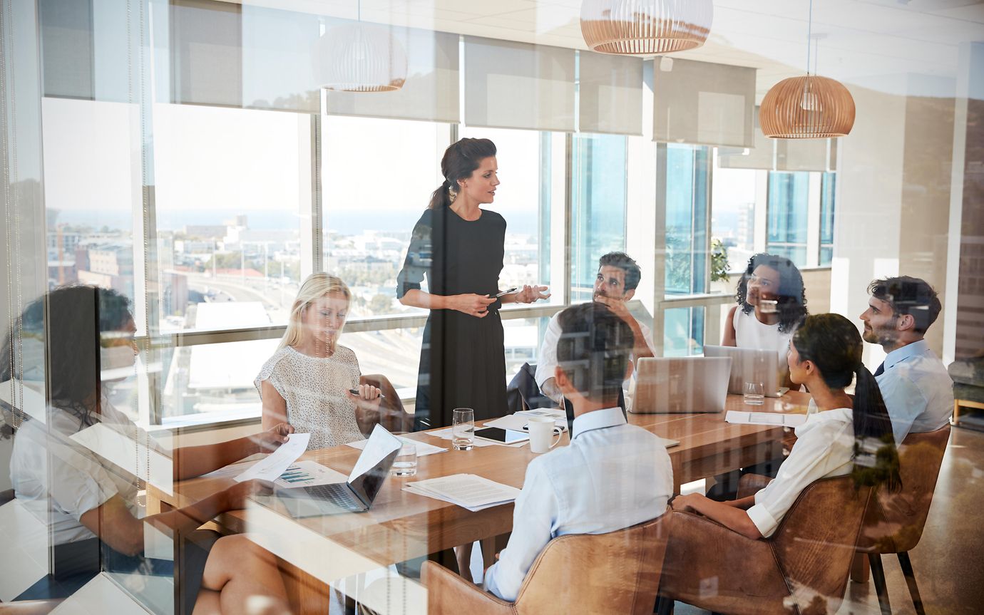 group of people around table in boardroom 