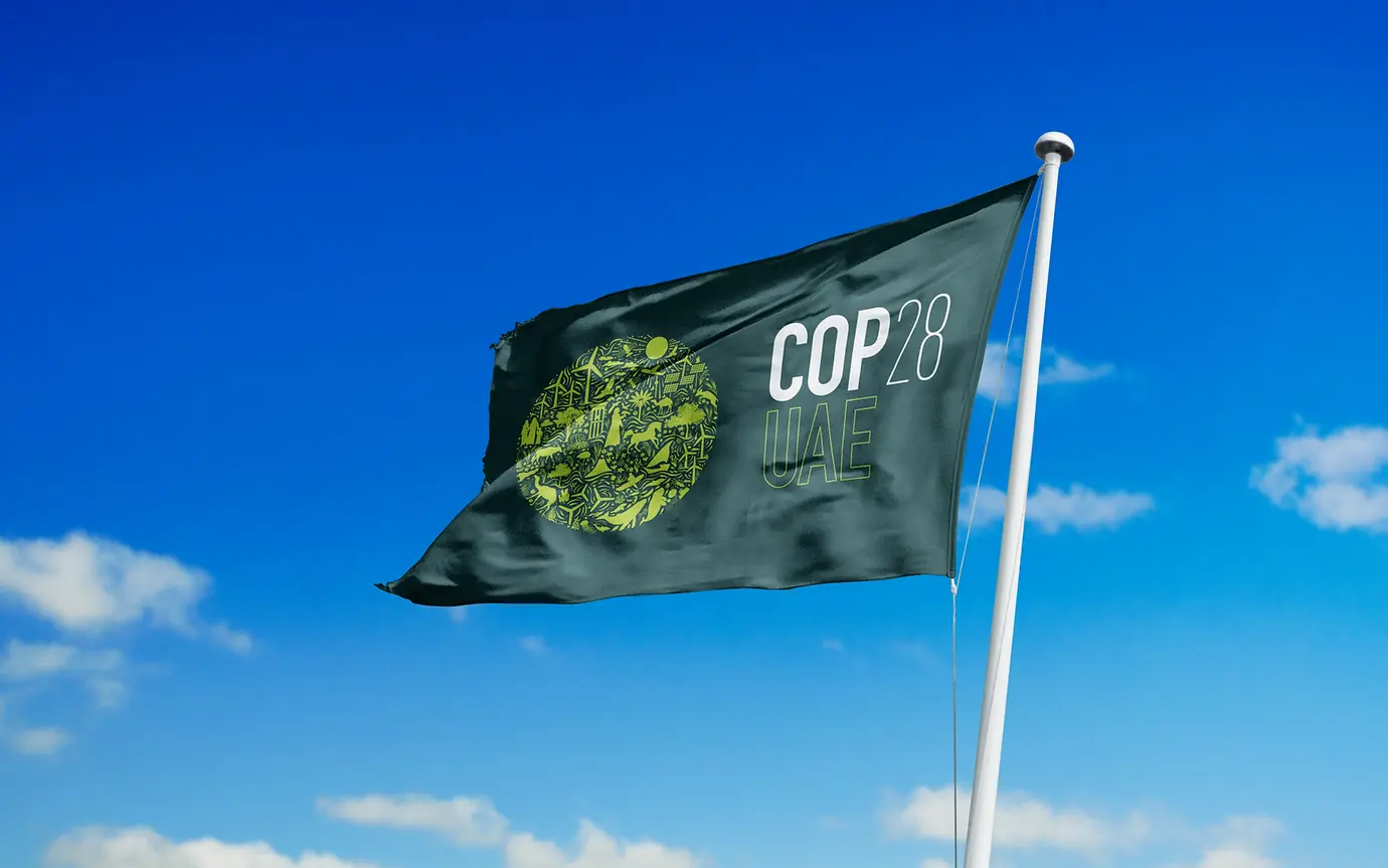 Cop 28 flag on blue sky