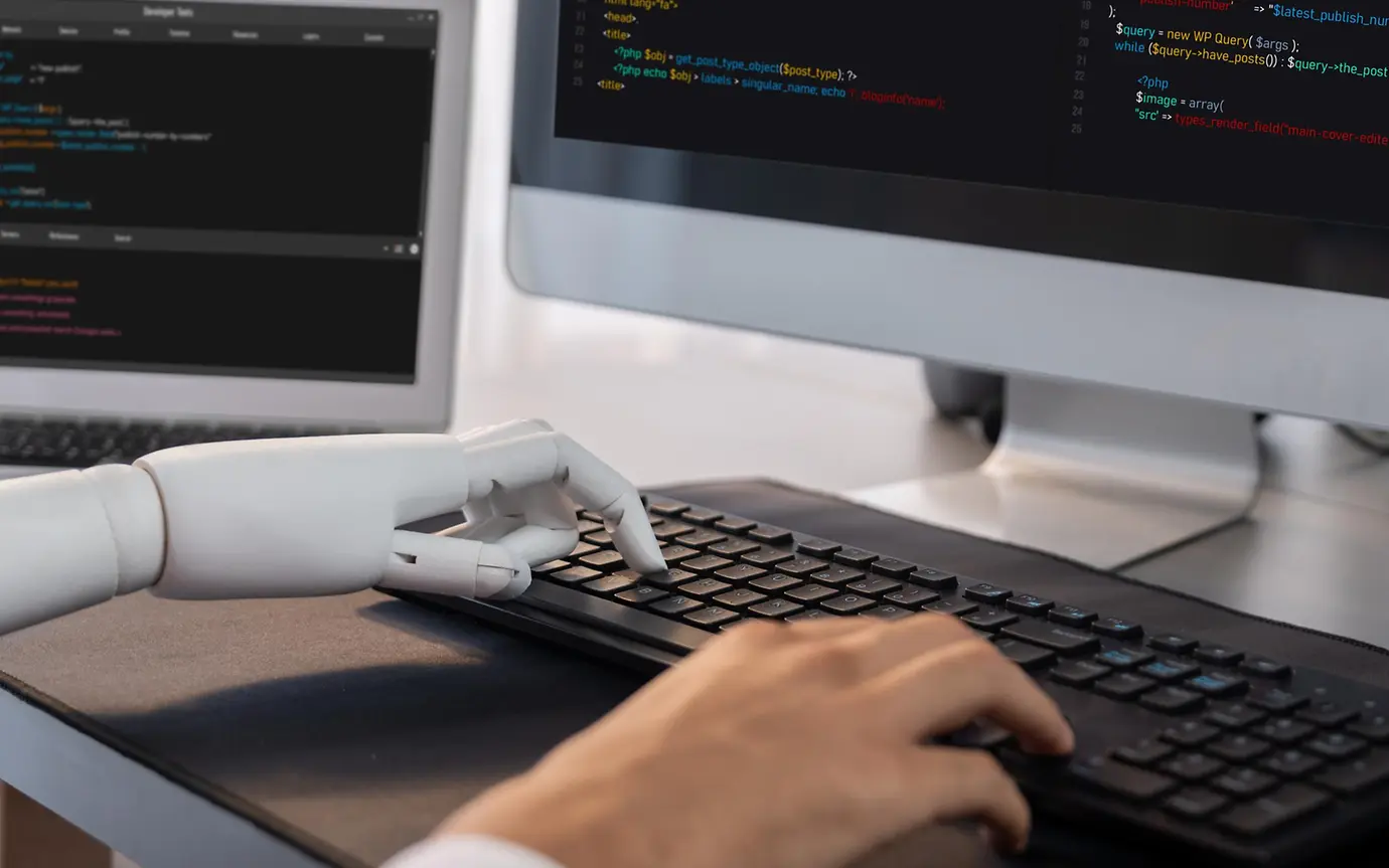 robot and hand on computer