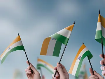people waving small Indian flags