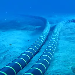 Two thick blue cables with bright horizontal stripes run parallel on the seabed, then separate in two opposite directions.