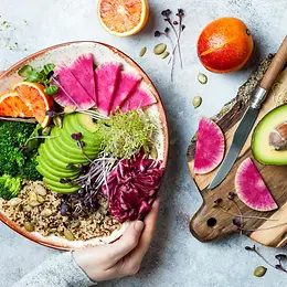 Colourful superfoods on a plate such as avocado, quinoa and olives