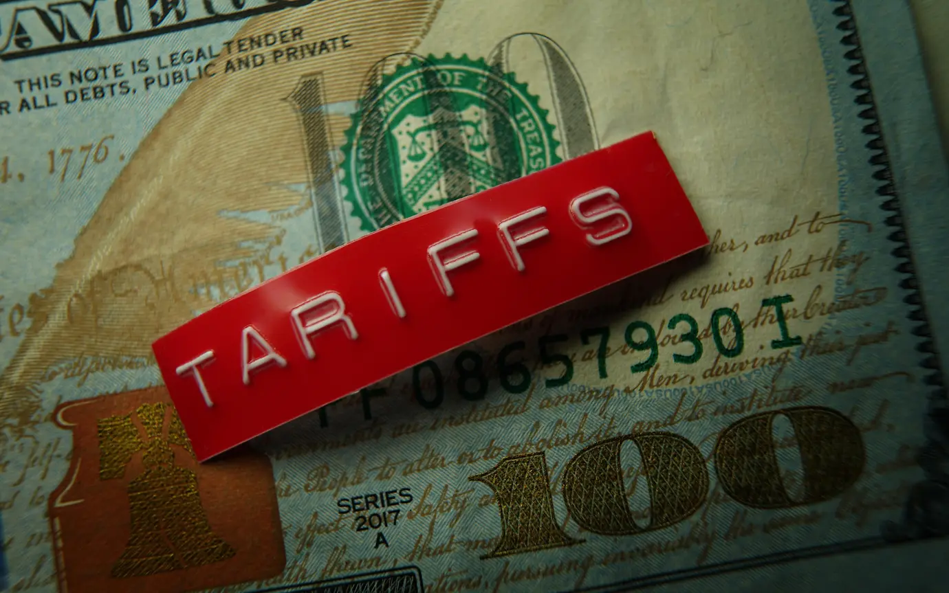 Red tariffs label on a hundred dollar bill