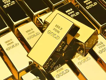Fine gold bars piled on top of each other.