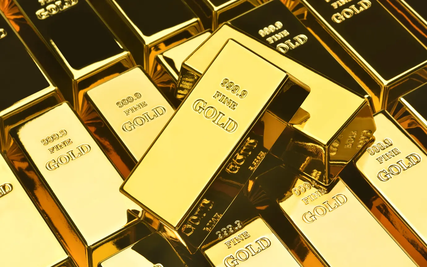 Fine gold bars piled on top of each other.