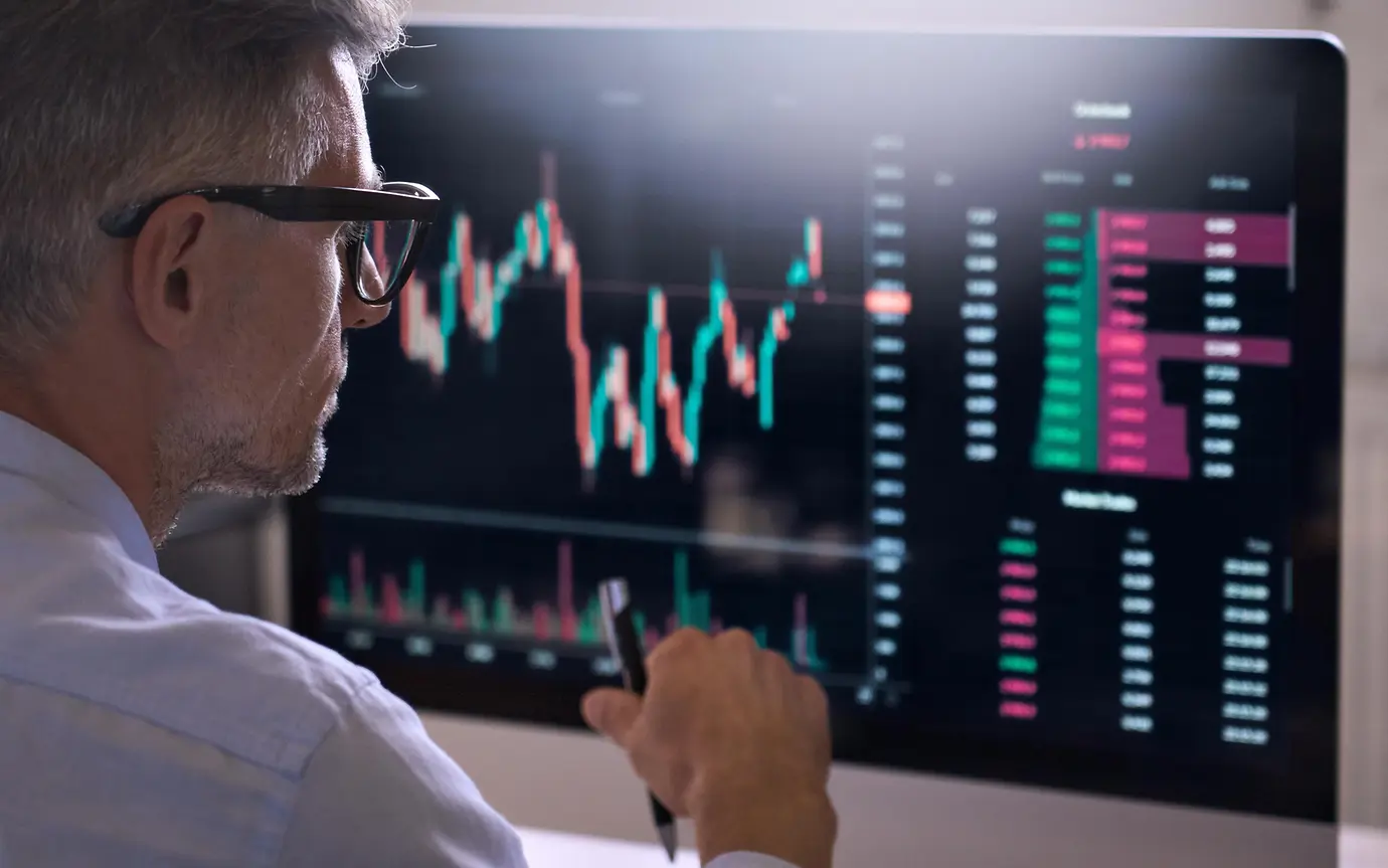 Crypto trader investor analyst broker using pc computer analyzing online cryptocurrency exchange stock market indexes charts investing money profit in trading platform stockmarket. Over shoulder view.