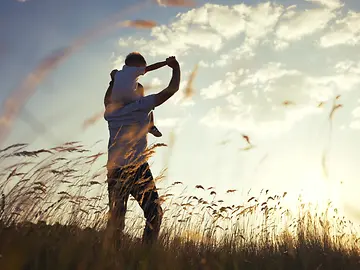Father and son in field