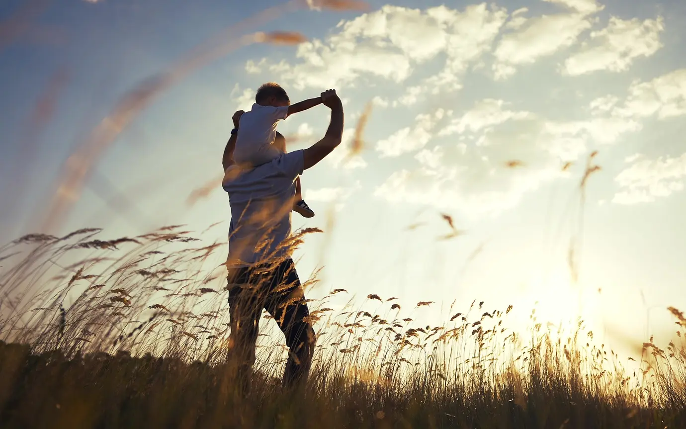Father and son in field