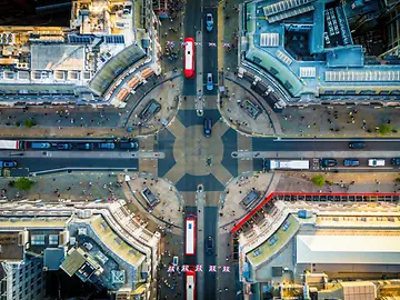Oxford Circus area, with busy roads, classic buildings, and red buses.