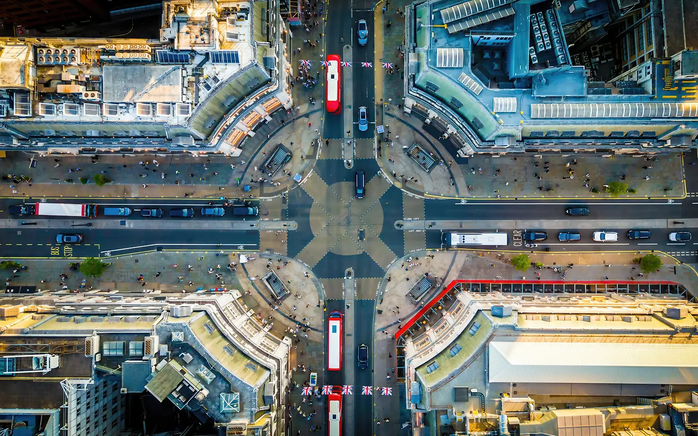 Oxford Circus area, with busy roads, classic buildings, and red buses.